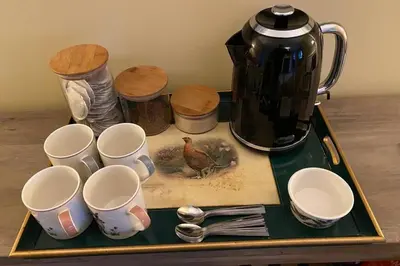 a tray with cups and spoons and a tea kettle at 2x King Bedrooms, private living room & bathroom in Thornhill
