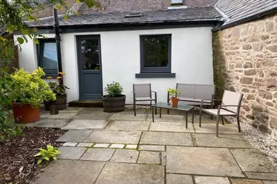 a patio with chairs and a table in front of a house at 2x King Bedrooms, private living room & bathroom in Thornhill