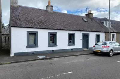a white house with a car parked in front of it at 2x King Bedrooms, private living room & bathroom in Thornhill