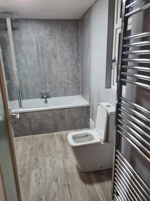 a bathroom with a toilet and a bath tub at Forth View Apartment in Stirling