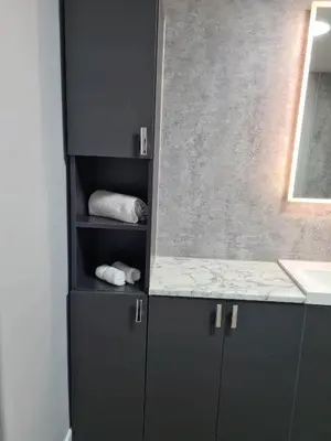 a bathroom with gray cabinets and a counter top at Forth View Apartment in Stirling