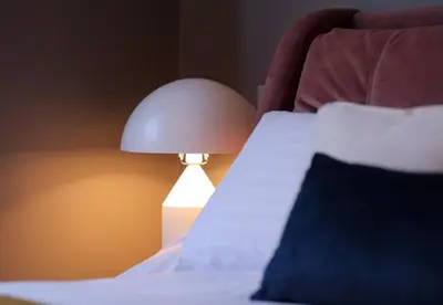 a bed with a lamp sitting next to a bed at Boutique 50 in Glasgow