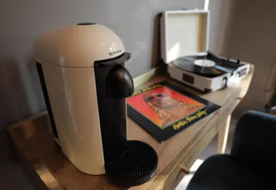 a coffee maker sitting on a table next to a book at Boutique 50 in Glasgow