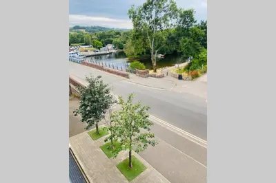 an aerial view of a street and a road with trees at Riverside View Apartment in Balloch, Loch Lomond in Balloch