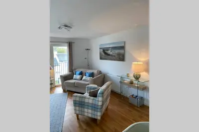 a living room with a couch and a chair at Riverside View Apartment in Balloch, Loch Lomond in Balloch