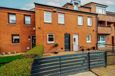 a red brick building with a black door at Dalmarnock Stay in Glasgow