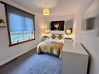 a small bedroom with a bed and a window at Central 1-Bed Apt Sleeps 4 5 mins to Station in Greenock