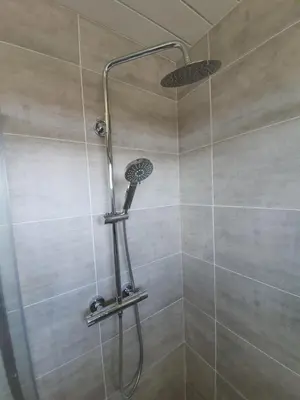 a shower with a shower head in a bathroom at PREMIER - Kenilworth House in Holytown