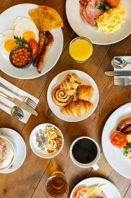 a table with plates of breakfast foods on it at Courtyard by Marriott Glasgow SEC in Glasgow