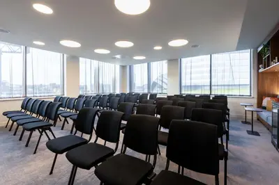 a large room with chairs and tables and windows at Courtyard by Marriott Glasgow SEC in Glasgow
