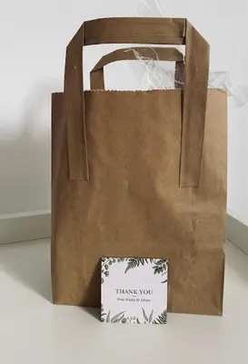 a paper bag with a thank you sign next to a chair at Glenclova - No 5 Bellyeoman, bright two bedroom apartment in Fife