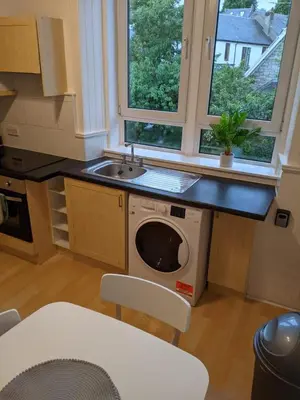 a kitchen with a sink and a washing machine at Glenclova - No 5 Bellyeoman, bright two bedroom apartment in Fife