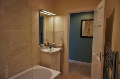 a bathroom with a sink and a tub and a toilet at 17 William Street in Helensburgh
