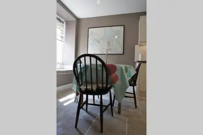 a dining room with a table and chairs and a window at 17 William Street in Helensburgh