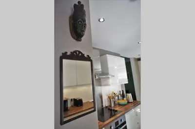 a mirror on a wall next to a kitchen at 17 William Street in Helensburgh