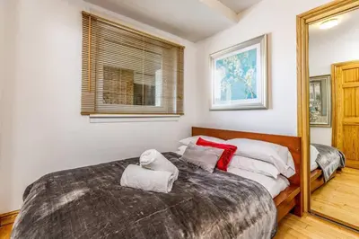 a bedroom with a large bed with towels on it at Fresh, modern West End apartment beside Hydro in Glasgow