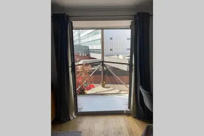an open window with a view of a balcony at Fresh, modern West End apartment beside Hydro in Glasgow