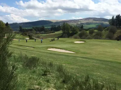 a group of people playing golf on a green field at Strathallan - Luxury 3 Bedroom Apartment, Gleneagles, Auchterarder in Auchterarder