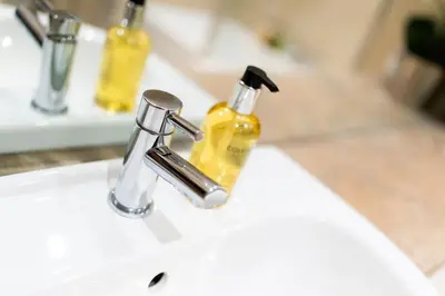 a bathroom sink with a soap dispenser on it at Strathallan - Luxury 3 Bedroom Apartment, Gleneagles, Auchterarder in Auchterarder