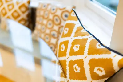 a group of pillows sitting on a couch at Strathallan - Luxury 3 Bedroom Apartment, Gleneagles, Auchterarder in Auchterarder