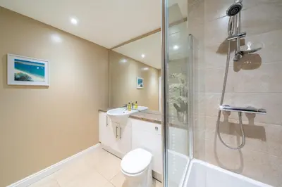 a bathroom with a shower and a toilet and a sink at Strathallan - Luxury 3 Bedroom Apartment, Gleneagles, Auchterarder in Auchterarder