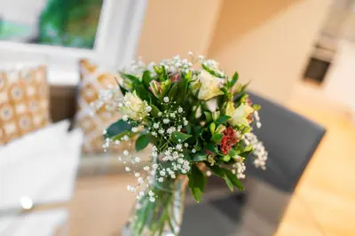 a vase with a bouquet of flowers on a table at Strathallan - Luxury 3 Bedroom Apartment, Gleneagles, Auchterarder in Auchterarder