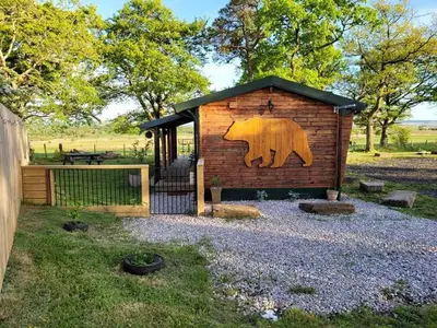a bear painted on the side of a building at Cosy wood cabin in rural area near national park in Cumnock