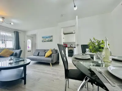 a living room with a table and a couch at Central Hamilton House in Hamilton