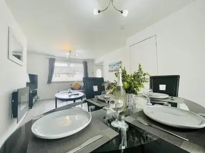 a dining room with a table with plates on it at Central Hamilton House in Hamilton