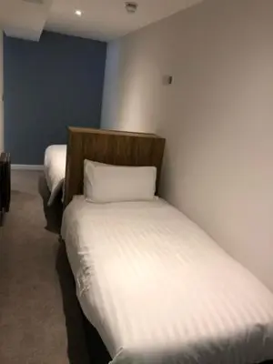 a bedroom with two beds in a room at Loch Lomond Hotel in Balloch