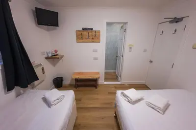 a small room with two beds and a table at Roam West in Fort William