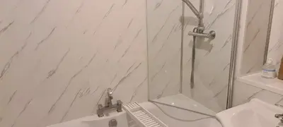 a bathroom with a shower and a sink at Espedair Apartment in Paisley
