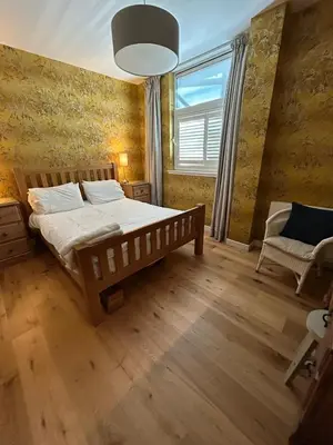 a bedroom with a large bed and a window at Glasgow Harbour Clyde Waterfront Apartment in Glasgow
