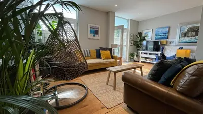 a living room with a couch and a swing at Glasgow Harbour Clyde Waterfront Apartment in Glasgow