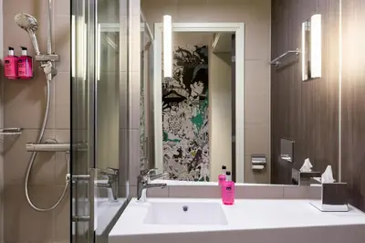 a bathroom with a sink and a mirror at Moxy Glasgow SEC in Glasgow