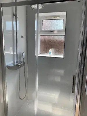 a shower in a bathroom with a window at Woodvale Flat, Renton, Loch Lomond in Renton