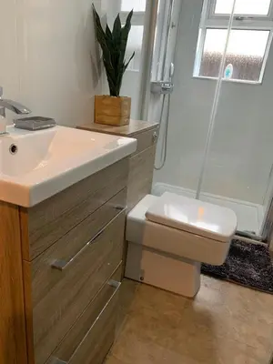 a bathroom with a sink and a toilet and a shower at Woodvale Flat, Renton, Loch Lomond in Renton