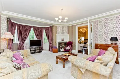 a living room with two couches and a tv at Luxury-3-bedroom Ramsay Garden Apartment next to Edinburgh Castle in Edinburgh