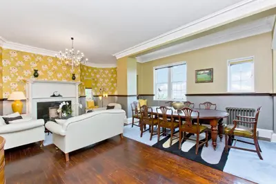 a living room with a table and a dining room at Luxury-3-bedroom Ramsay Garden Apartment next to Edinburgh Castle in Edinburgh