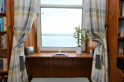 a window with a view of the water in a room at Arthur's Seat in Innellan