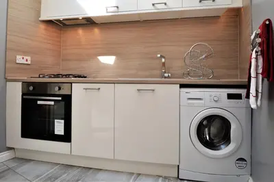 a kitchen with a washing machine and a sink at Arthur's Seat in Innellan