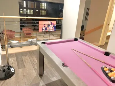 a pink pool table in a room with a tv at Glasgow City Centre G1 PENTHOUSE with RiverViews - Duplex - 4 Bedrooms, 3 Bathrooms, Kitchen, 1 Living room, 1 Dining room, 2 Terraces, Parking, Top Floor, 2050 sq ft, Merchant City in Glasgow