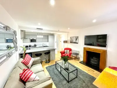 a living room with a couch and a fireplace at Prime Edinburgh New Town. Newly reno'd cosy nest in Edinburgh