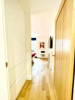 a hallway with a door leading to a living room at Prime Edinburgh New Town. Newly reno'd cosy nest in Edinburgh