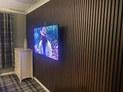 a television hanging on a wall in a room at Holiday Apartment, Balloch, Loch Lomond in Balloch