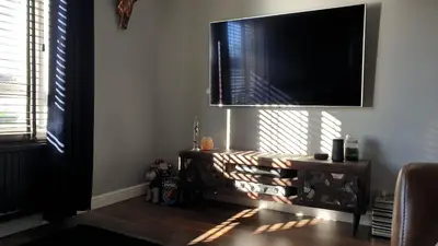 a living room with a flat screen tv on a wall at Holiday Apartment, Balloch, Loch Lomond in Balloch