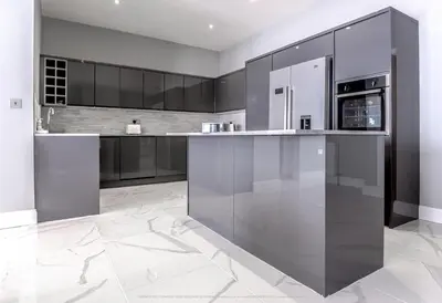 a kitchen with stainless steel appliances and black cabinets at 4 Bed-Sleeps 8- Free Parking-Pets-Hot Tub in Kelty