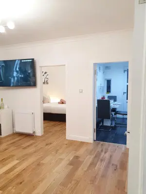 an empty room with a bed and a desk at Glasgow Comfortable and Modern 3 Bedroom Mid Terraced Villa in Glasgow