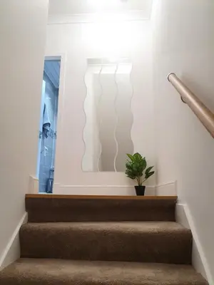 a stairway with a potted plant on the wall at Glasgow Comfortable and Modern 3 Bedroom Mid Terraced Villa in Glasgow