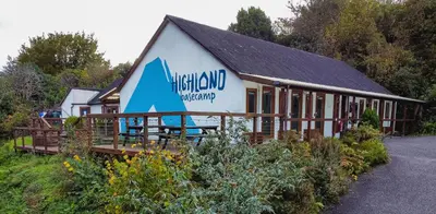 a building with a sign on the side of it at Highland Basecamp in Lochaline